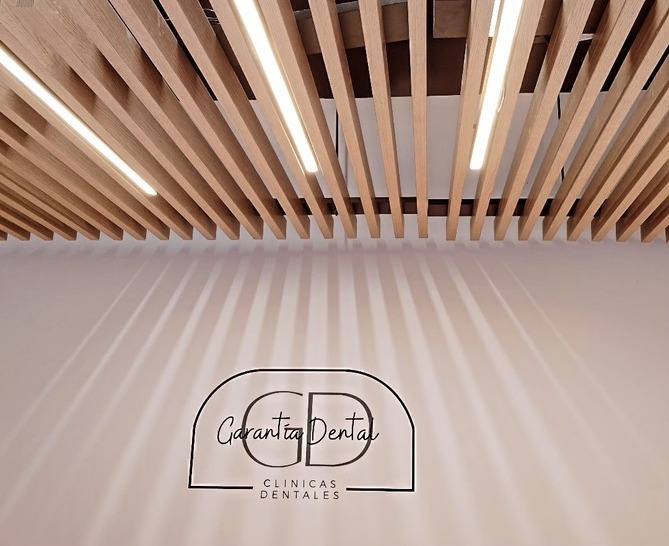 logo pared garantia dental nueva clinica techo madera